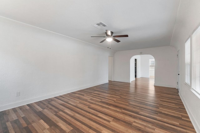 empty room with ceiling fan and dark hardwood / wood-style flooring