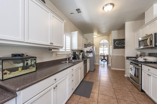 kitchen featuring white cabinetry, sink, and appliances with stainless steel finishes