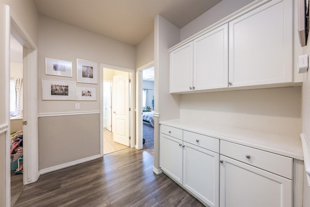 interior space with white cabinets and dark hardwood / wood-style floors