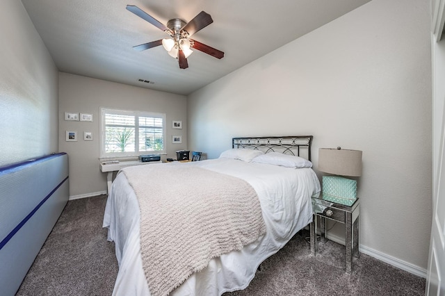 bedroom featuring ceiling fan and dark carpet