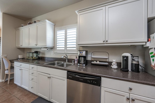 kitchen with dishwasher, white cabinets, light tile patterned floors, and sink