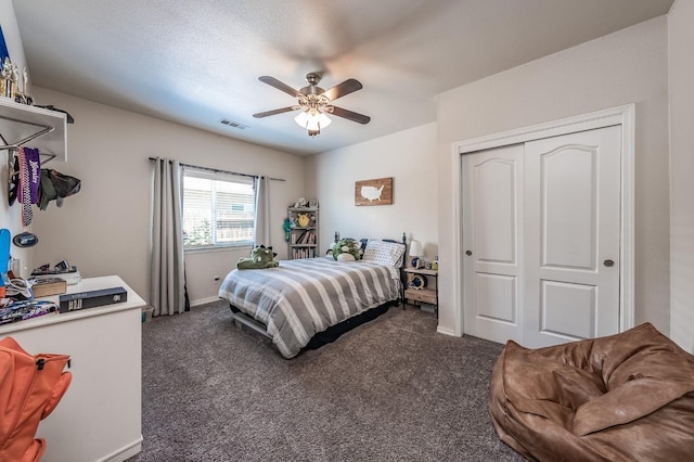 bedroom featuring ceiling fan, a closet, and dark carpet