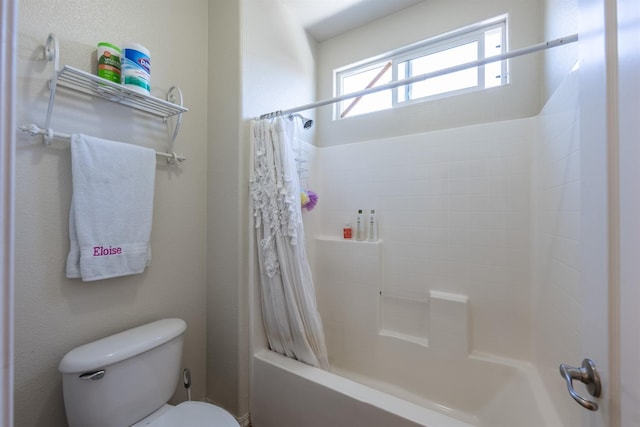 bathroom featuring shower / bath combination with curtain and toilet