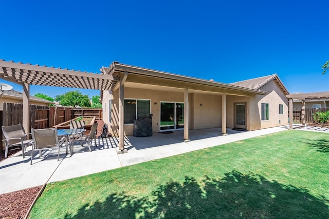 rear view of property featuring a patio and a lawn