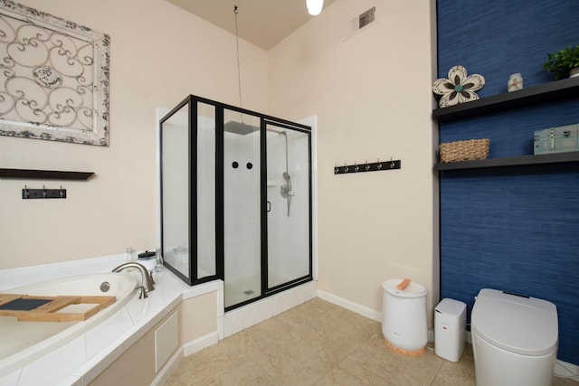 bathroom featuring tile patterned flooring, plus walk in shower, and toilet