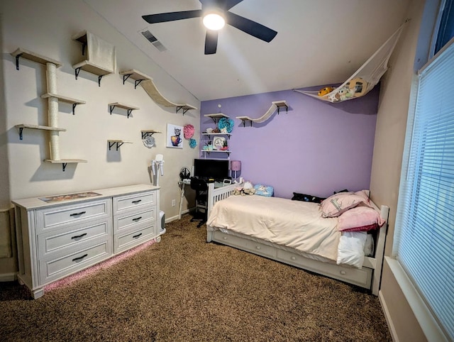 bedroom with ceiling fan, lofted ceiling, and dark carpet