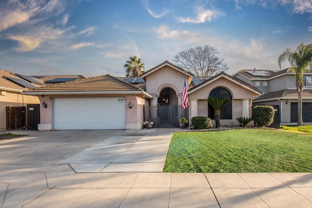 single story home with a garage, a front lawn, and solar panels