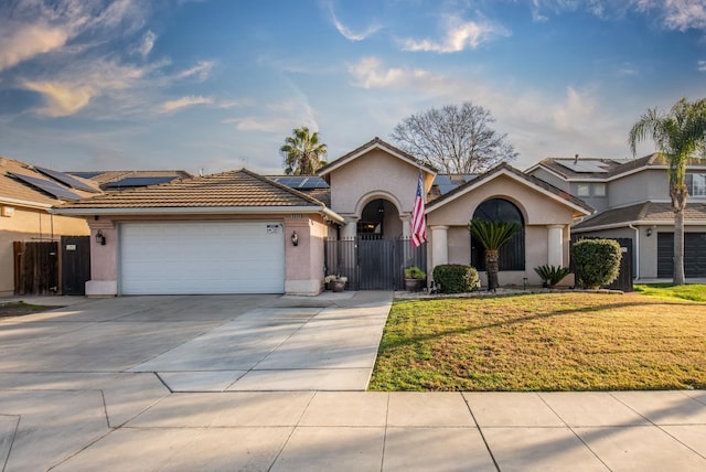 view of front facade with a garage, a front yard, and solar panels