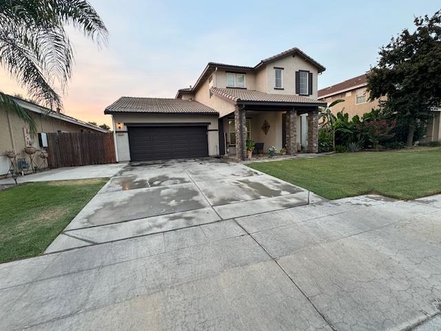 view of front of home featuring a garage and a yard