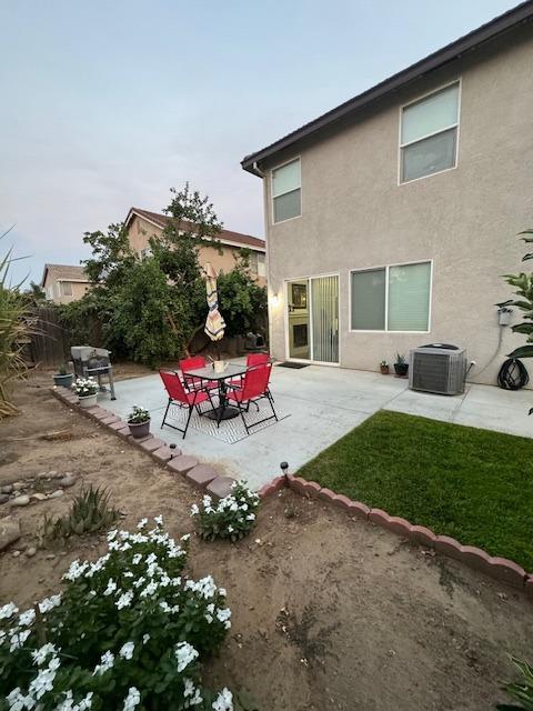 back of property with a patio area and central air condition unit