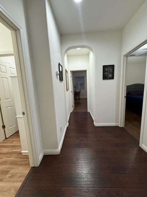 corridor featuring dark hardwood / wood-style floors