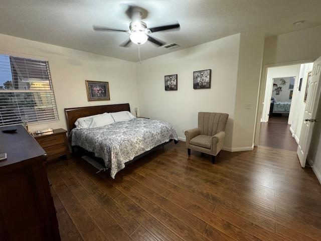 bedroom featuring ceiling fan and dark wood-type flooring