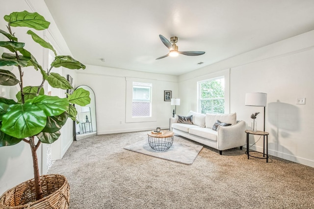 carpeted living room with ceiling fan