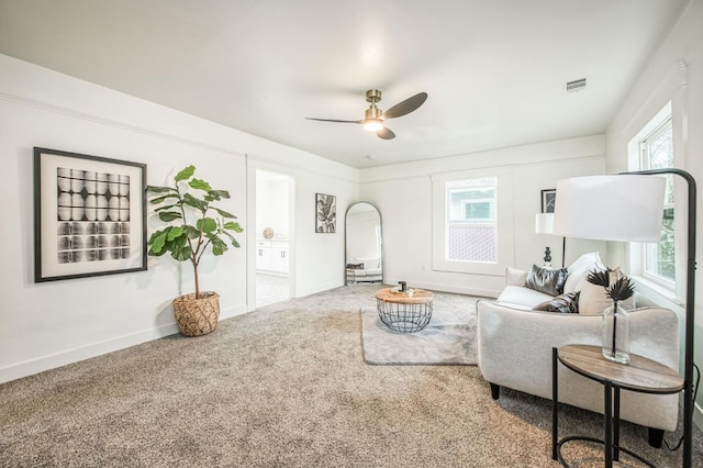 living room featuring carpet and ceiling fan