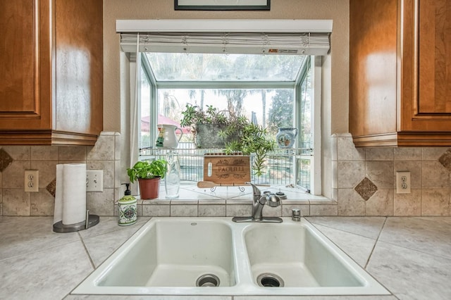 kitchen featuring tile counters, decorative backsplash, and sink