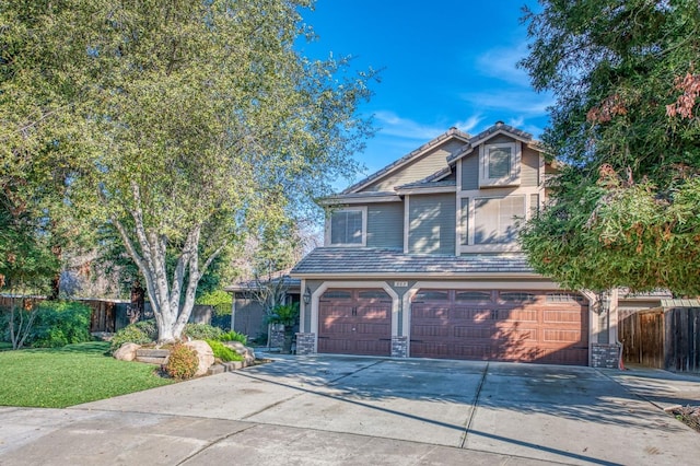 view of front of home with a front lawn and a garage