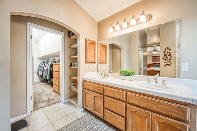 bathroom featuring ceiling fan, built in features, and vanity