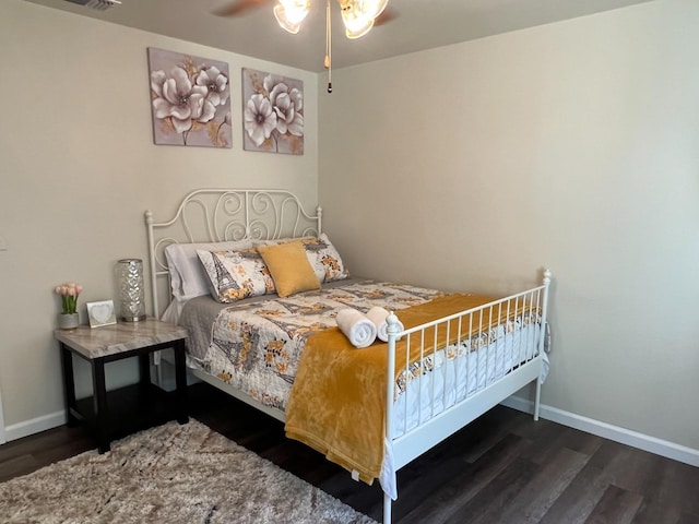 bedroom with ceiling fan and dark hardwood / wood-style flooring