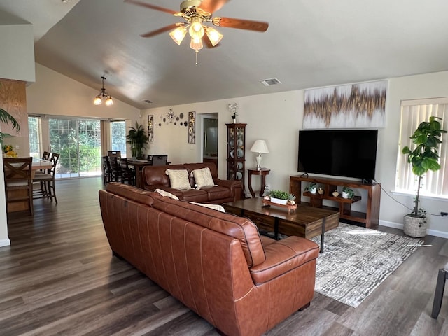 living area featuring ceiling fan, visible vents, baseboards, vaulted ceiling, and dark wood-style floors