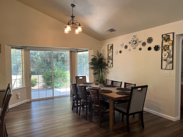 dining area featuring dark hardwood / wood-style floors, lofted ceiling, and a notable chandelier