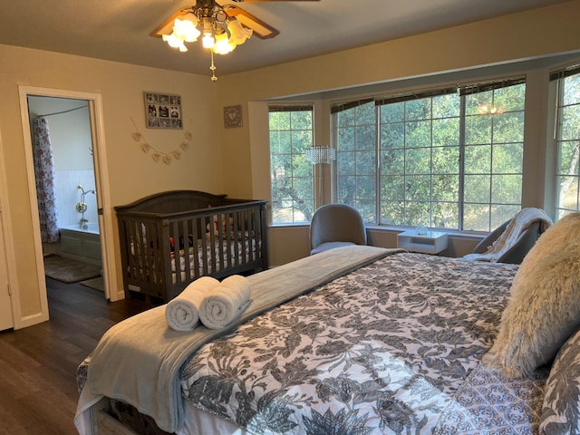 bedroom featuring ensuite bathroom, ceiling fan, and dark wood-type flooring