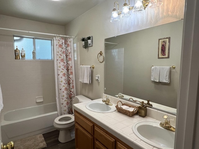 full bathroom with hardwood / wood-style floors, vanity, toilet, and shower / bathtub combination with curtain