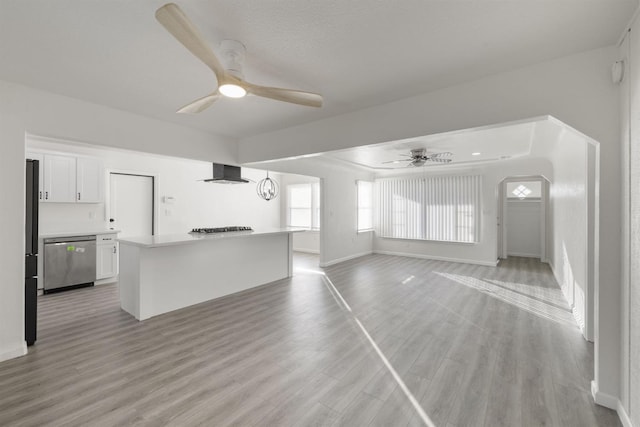 unfurnished living room with ceiling fan and light hardwood / wood-style flooring