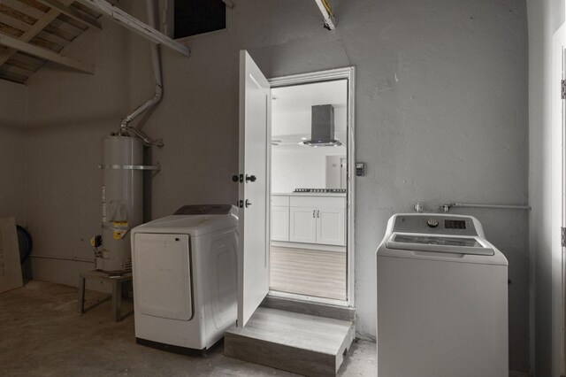 washroom featuring secured water heater and washer / clothes dryer