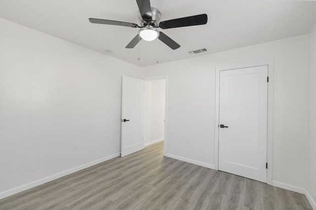 unfurnished bedroom with ceiling fan and light hardwood / wood-style floors