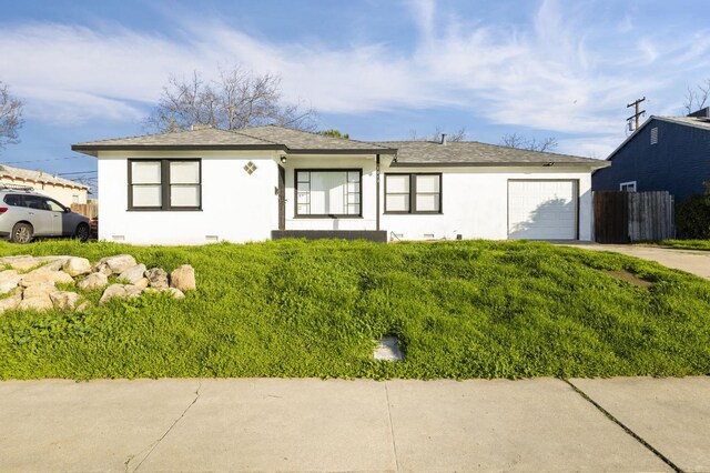 ranch-style home featuring a front yard and a garage