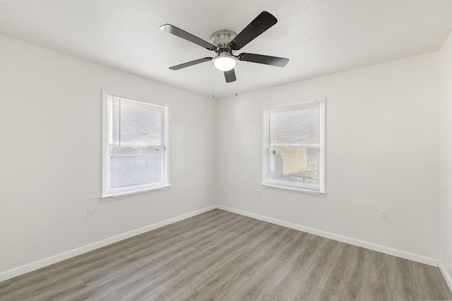 empty room with light hardwood / wood-style flooring and ceiling fan