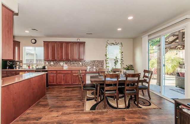 dining room featuring dark hardwood / wood-style flooring and plenty of natural light