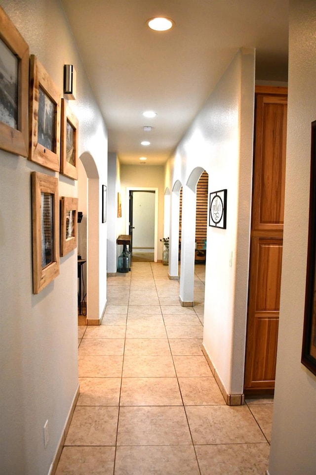 corridor with light tile patterned flooring