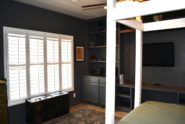 bedroom with ceiling fan and multiple windows