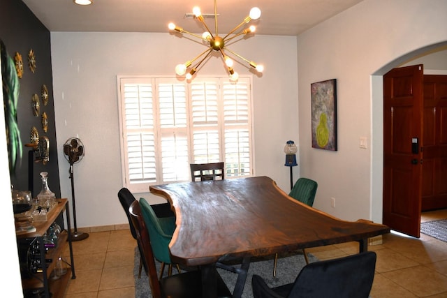 dining space featuring light tile patterned floors and a chandelier