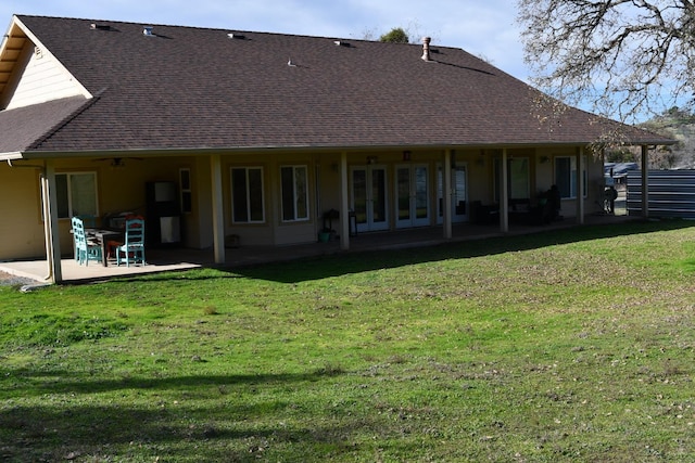 back of house featuring a patio area and a lawn