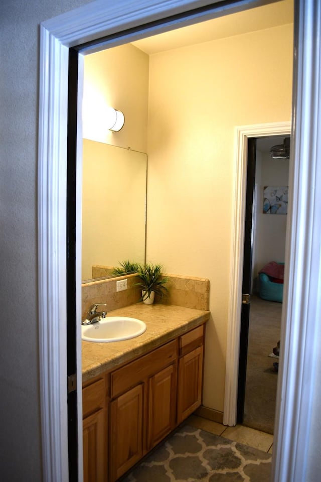 bathroom with tile patterned floors and vanity