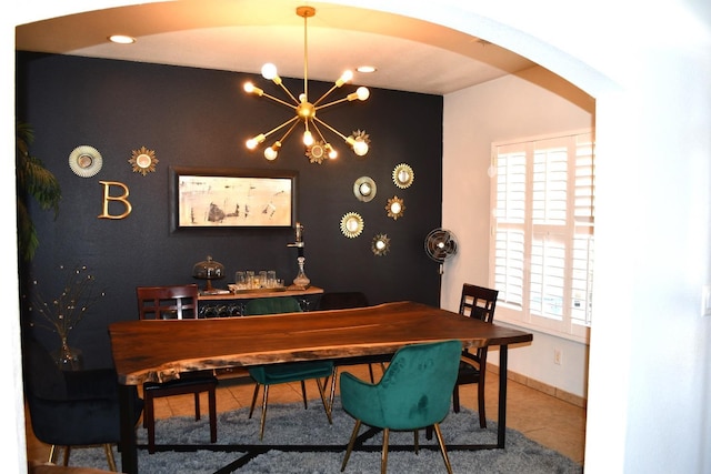 dining room with tile patterned floors and a notable chandelier