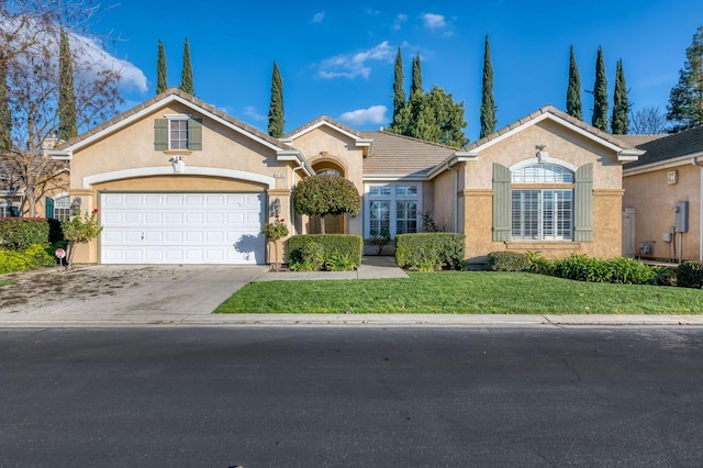 ranch-style house with a garage and a front yard