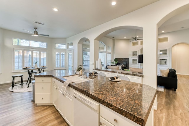 kitchen featuring white cabinetry, sink, a kitchen island with sink, ceiling fan, and white dishwasher