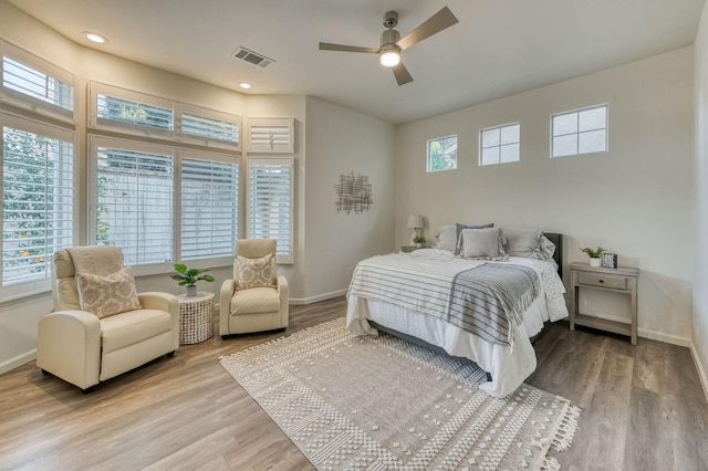 bedroom with light hardwood / wood-style floors and ceiling fan