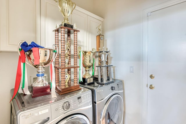 washroom featuring independent washer and dryer and cabinets