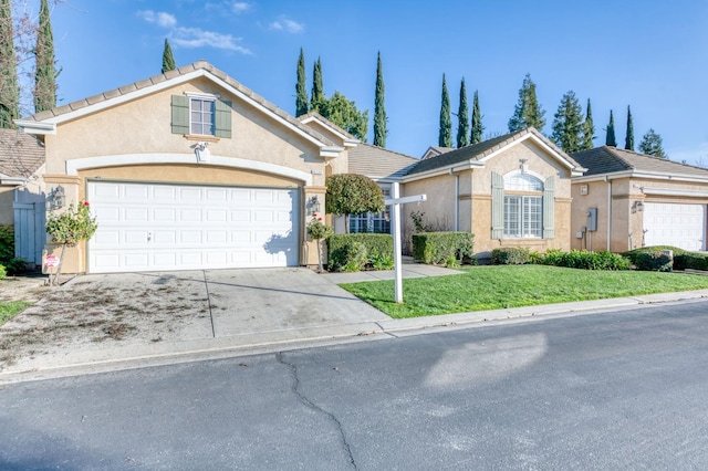 single story home featuring a garage and a front lawn