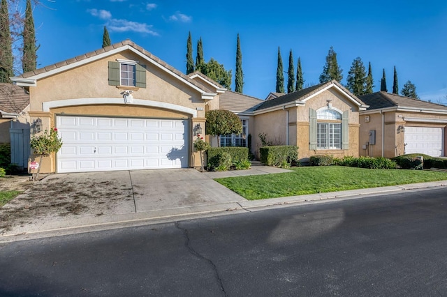 ranch-style home featuring a garage and a front lawn