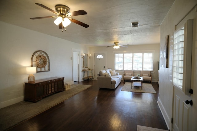 living room with ceiling fan and dark hardwood / wood-style flooring