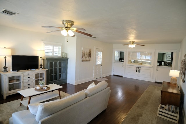 living room with dark hardwood / wood-style floors and ceiling fan