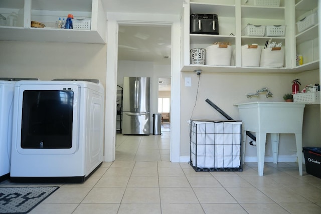 laundry room featuring light tile patterned floors and washer / clothes dryer