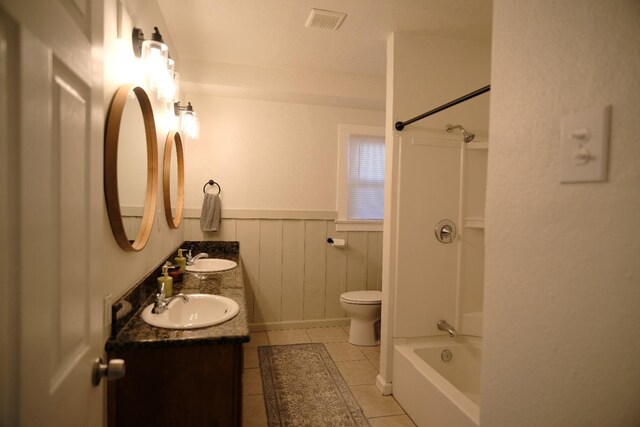 full bathroom with tile patterned floors, vanity, toilet, and shower / tub combination