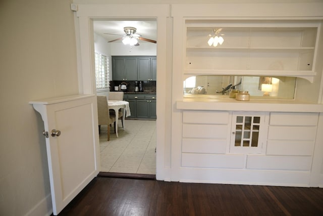 interior space featuring hardwood / wood-style flooring, decorative backsplash, and ceiling fan