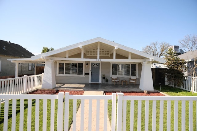 view of front of property with a porch and a front lawn